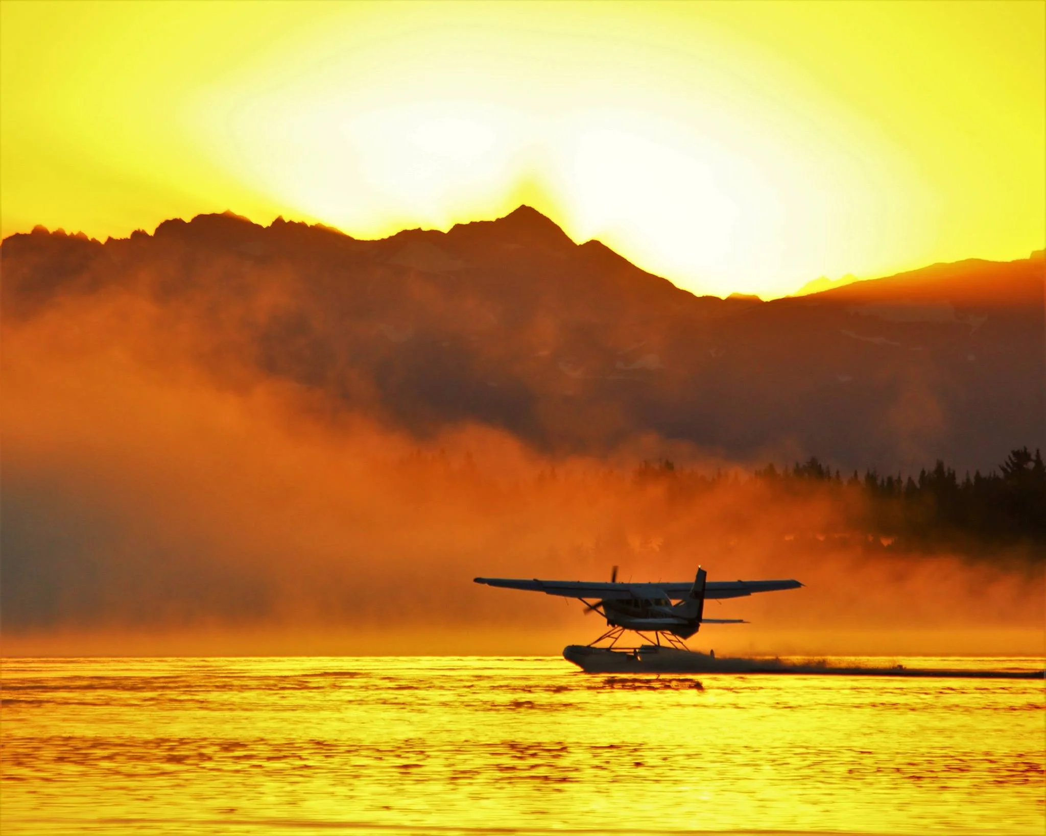 airplane landing in the water at sunset